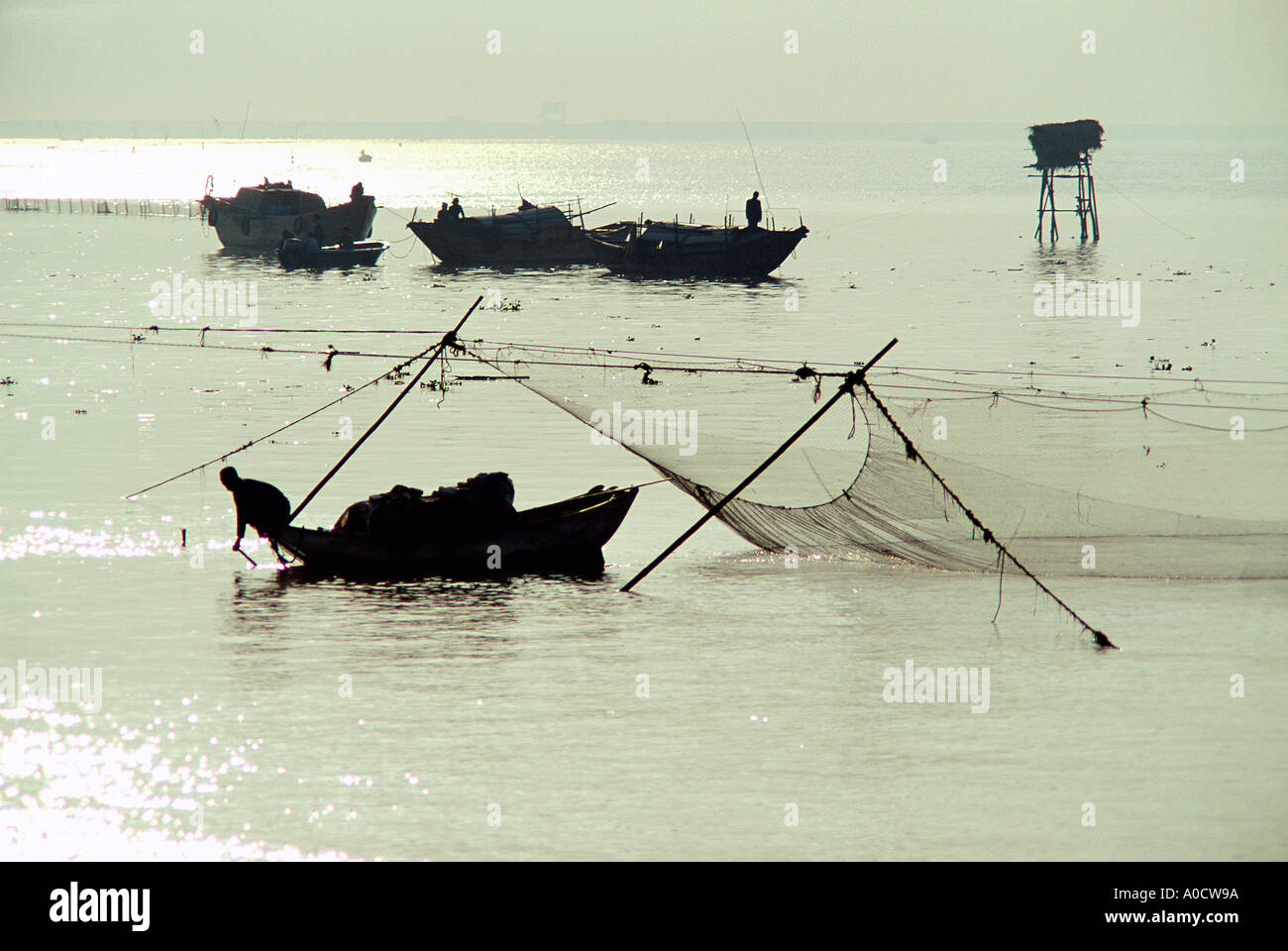 Fishing boats tending fixed nets in the mouth of the Pearl River near Shenzhen, Guangdong