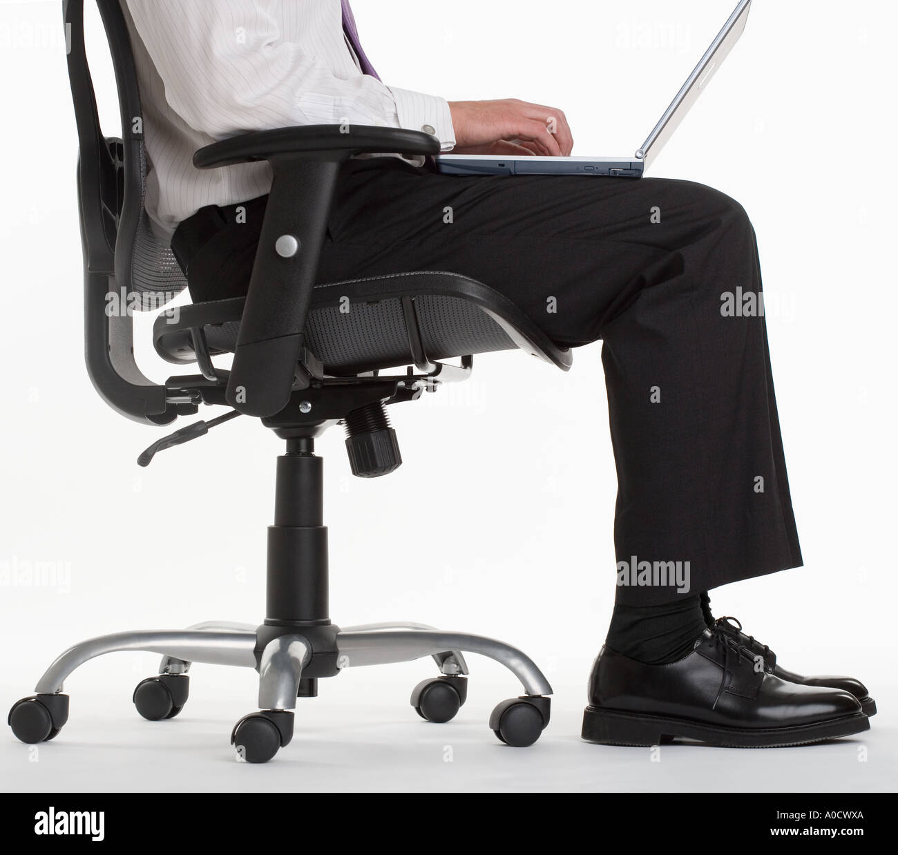 Seated businessman using laptop computer Stock Photo