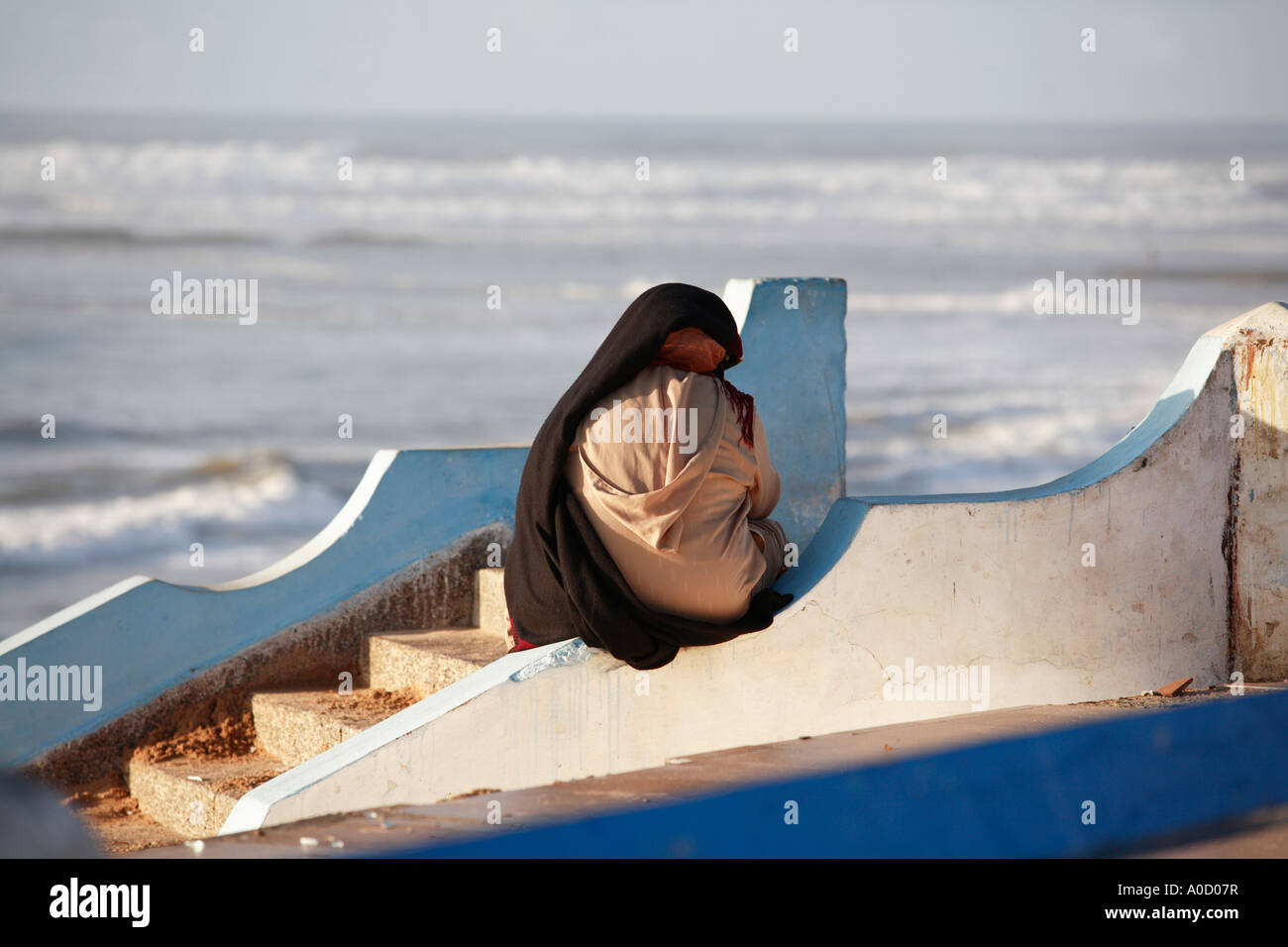 A Moroccan Lady Shelters from the Sun at Sidi Bouzid Stock Photo