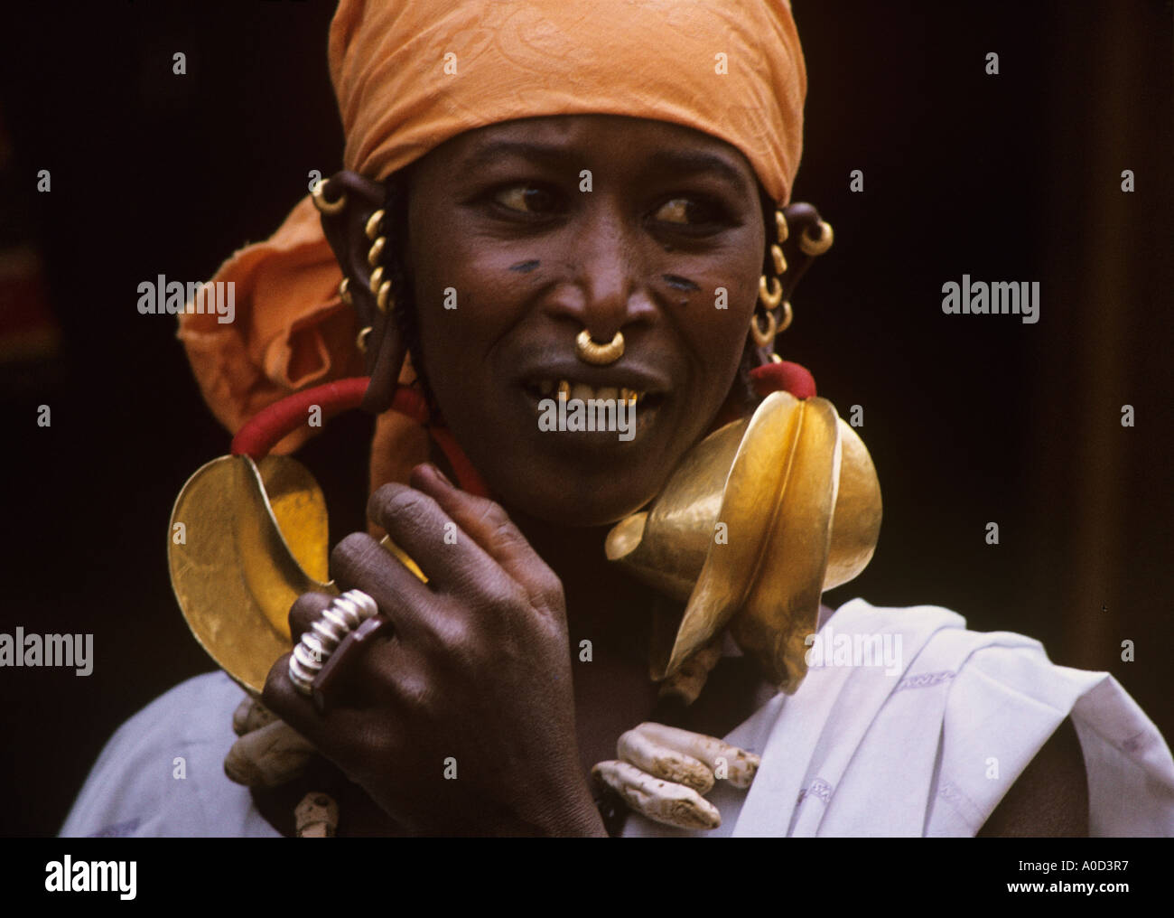 Huge earrings known as Kwottenai Kanye Hammered gold earrings displays Fulani woman s wealth South of The Niger River Stock Photo