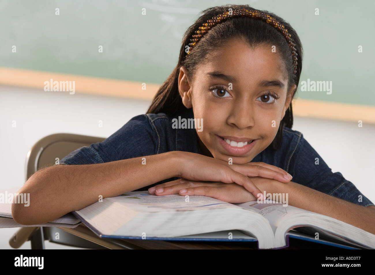 Young girl in classroom Stock Photo - Alamy