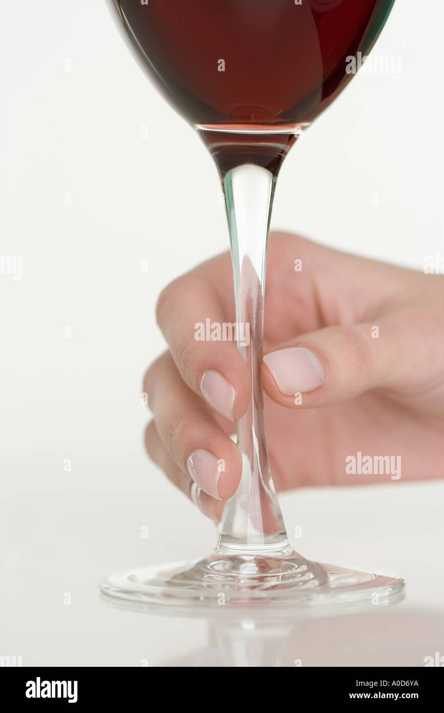 Female hand holding glass of wine Stock Photo - Alamy