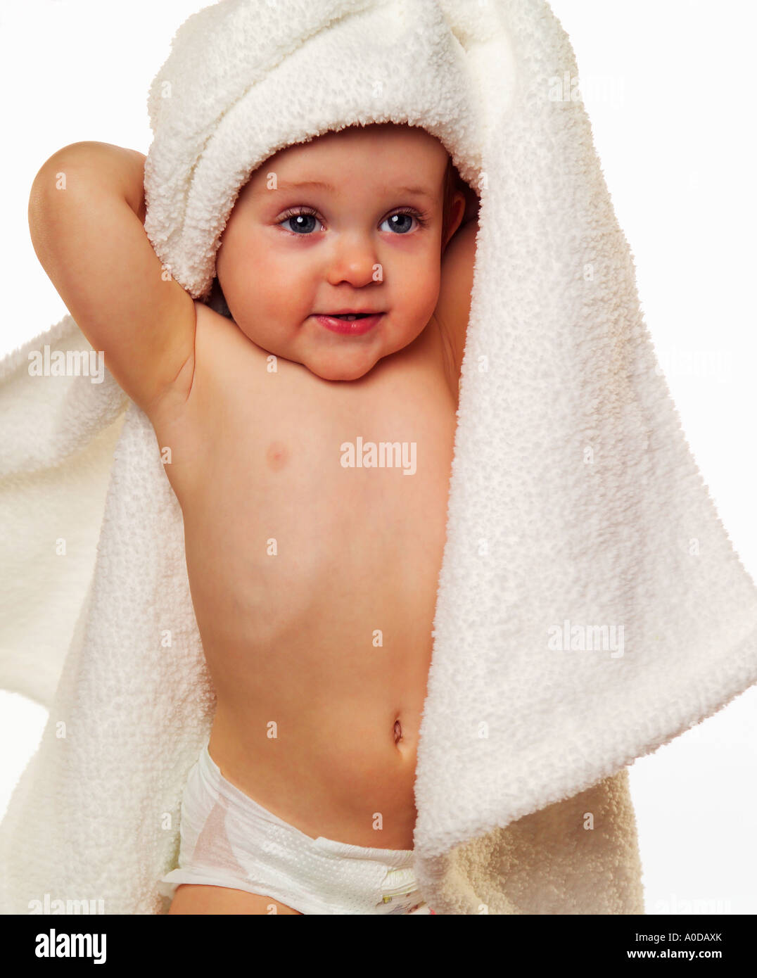 Baby with white blanket over her head, smiling Stock Photo Alamy
