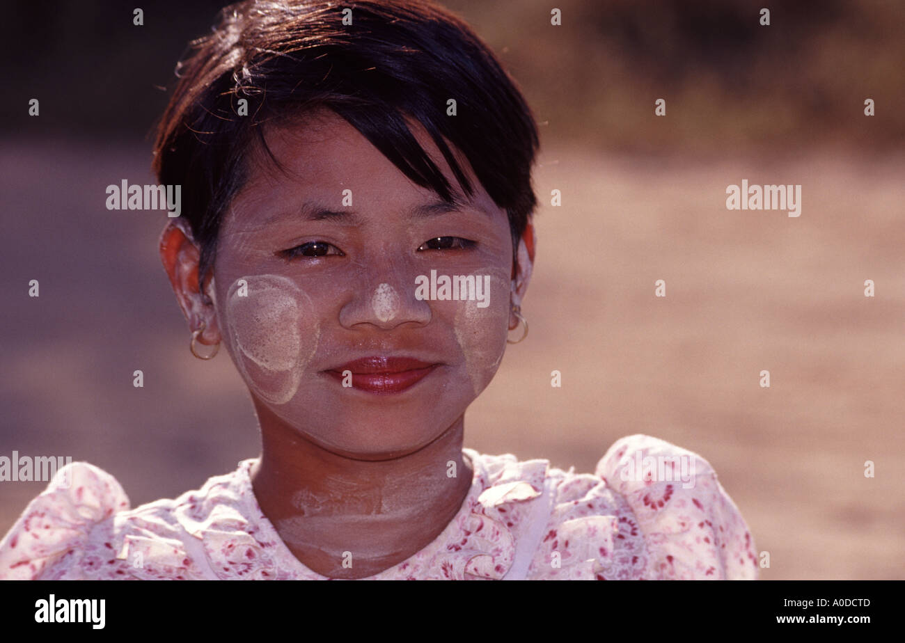 a young girl from Myanmar / Burma is wearing Tanaka on her face Stock Photo
