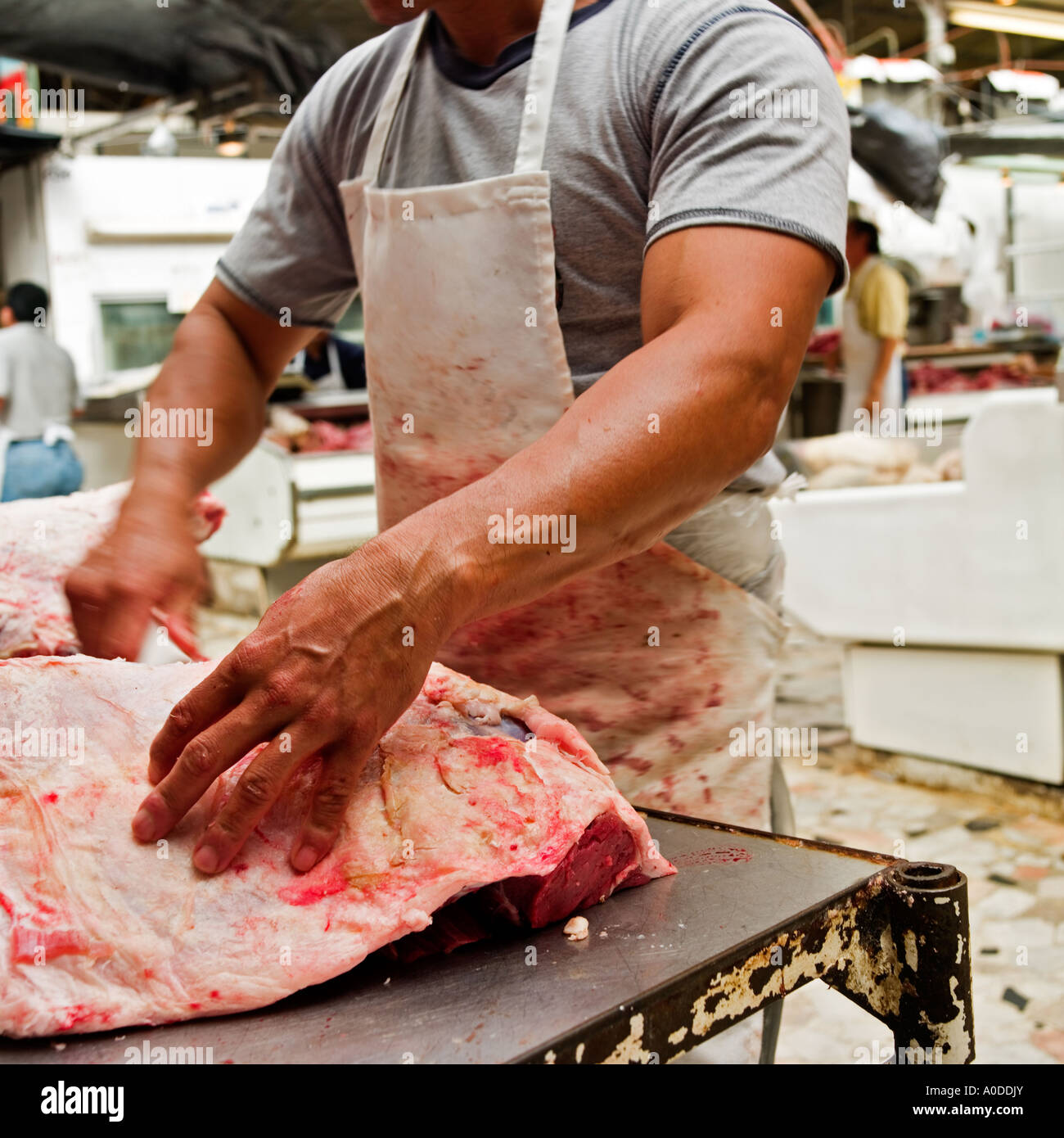 Strong arm of a butcher preparing meat No model release required, crop, blur, distance means people unrecognizable Stock Photo