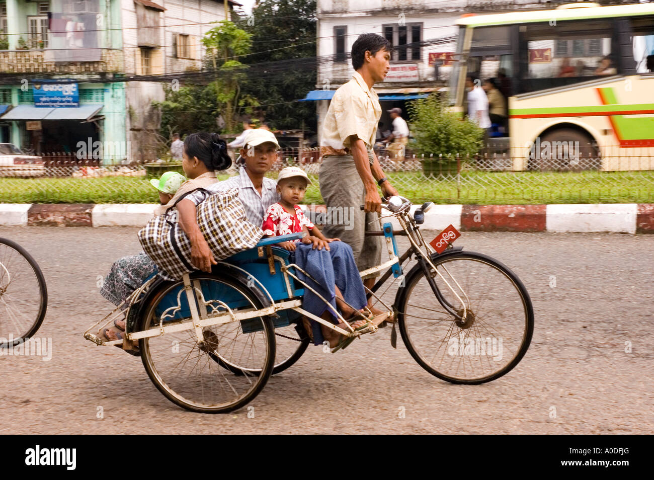 Stock photograph of a loaded trishaw on the main street of Bago in ...