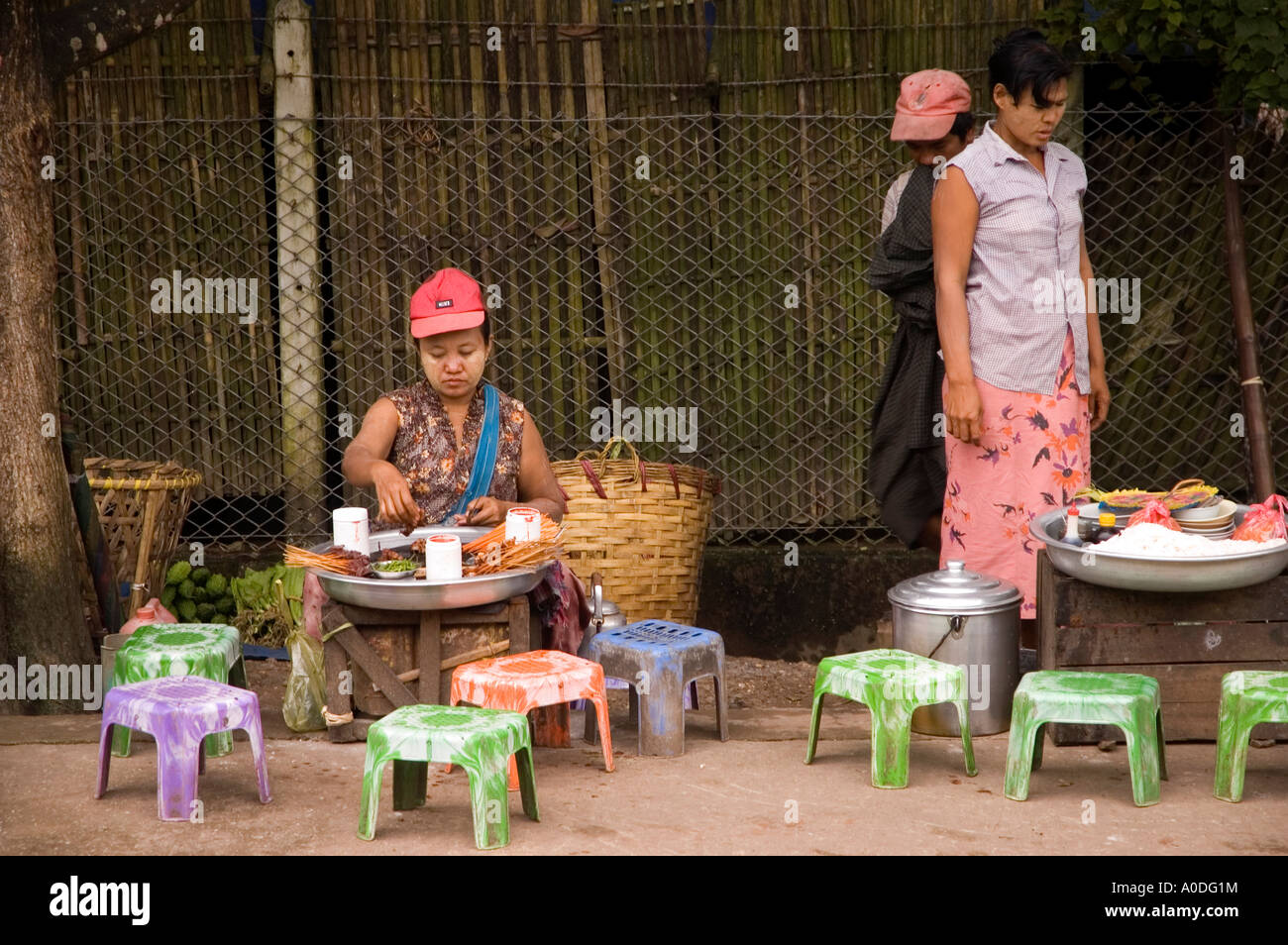 Stock photograph of hawkers selling snacks on a suburban train station in Yangon in Myanmar 2006 Stock Photo