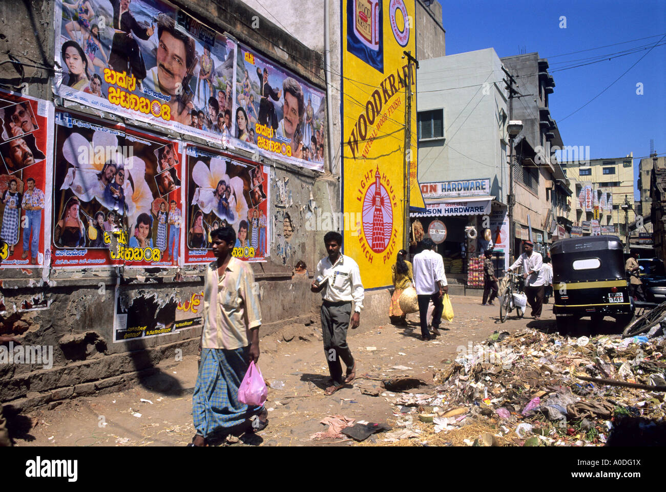 A street scene with movie posters on a wall in Bangalore India Stock