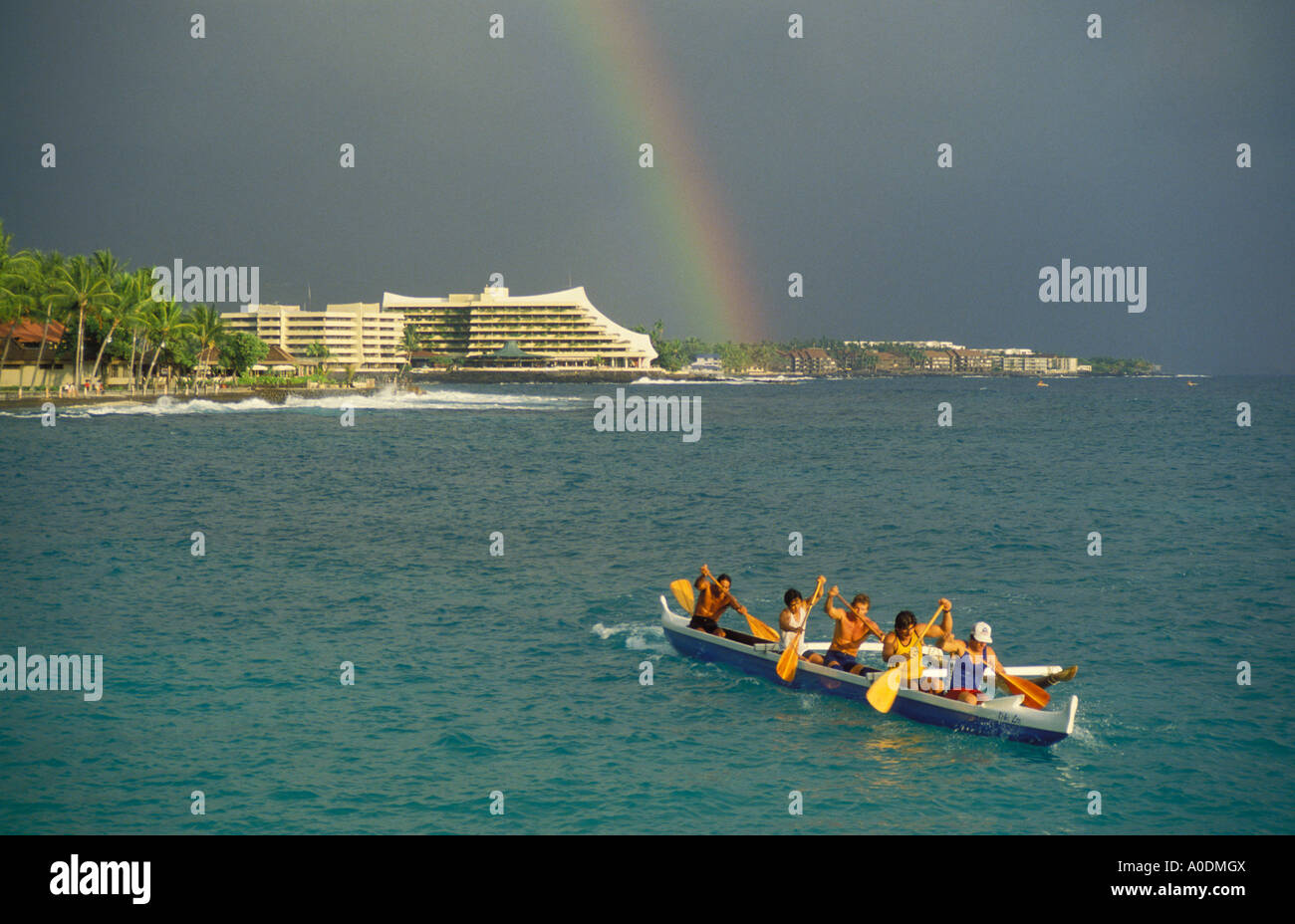 Outrigger canoe paddlers rainbow and Royal Kona Resort Kailua Bay Kailua Kona Island of Hawaii