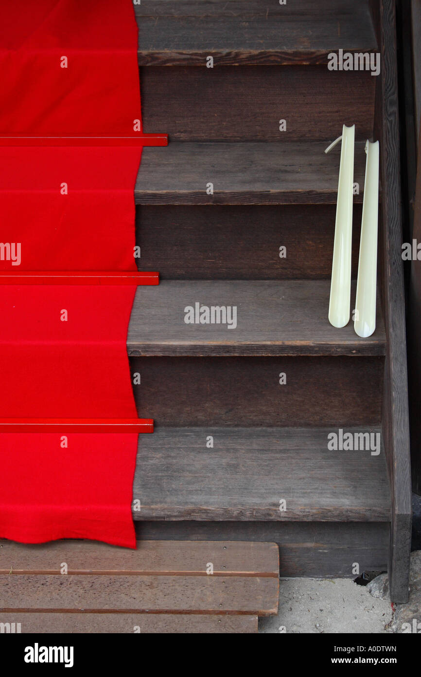 Shoe horns and a red carpet on steps at the Shimogano shrine in Kyoto
