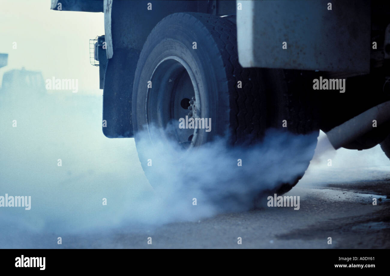 Diesel lorry starting up in early morning and belching smoke England Stock Photo