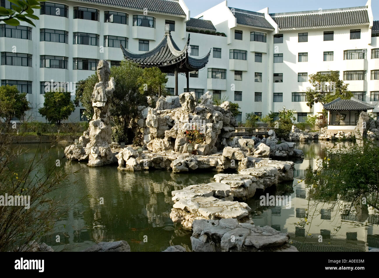 Stepping stones leading to a small pagoda on an island in a lake