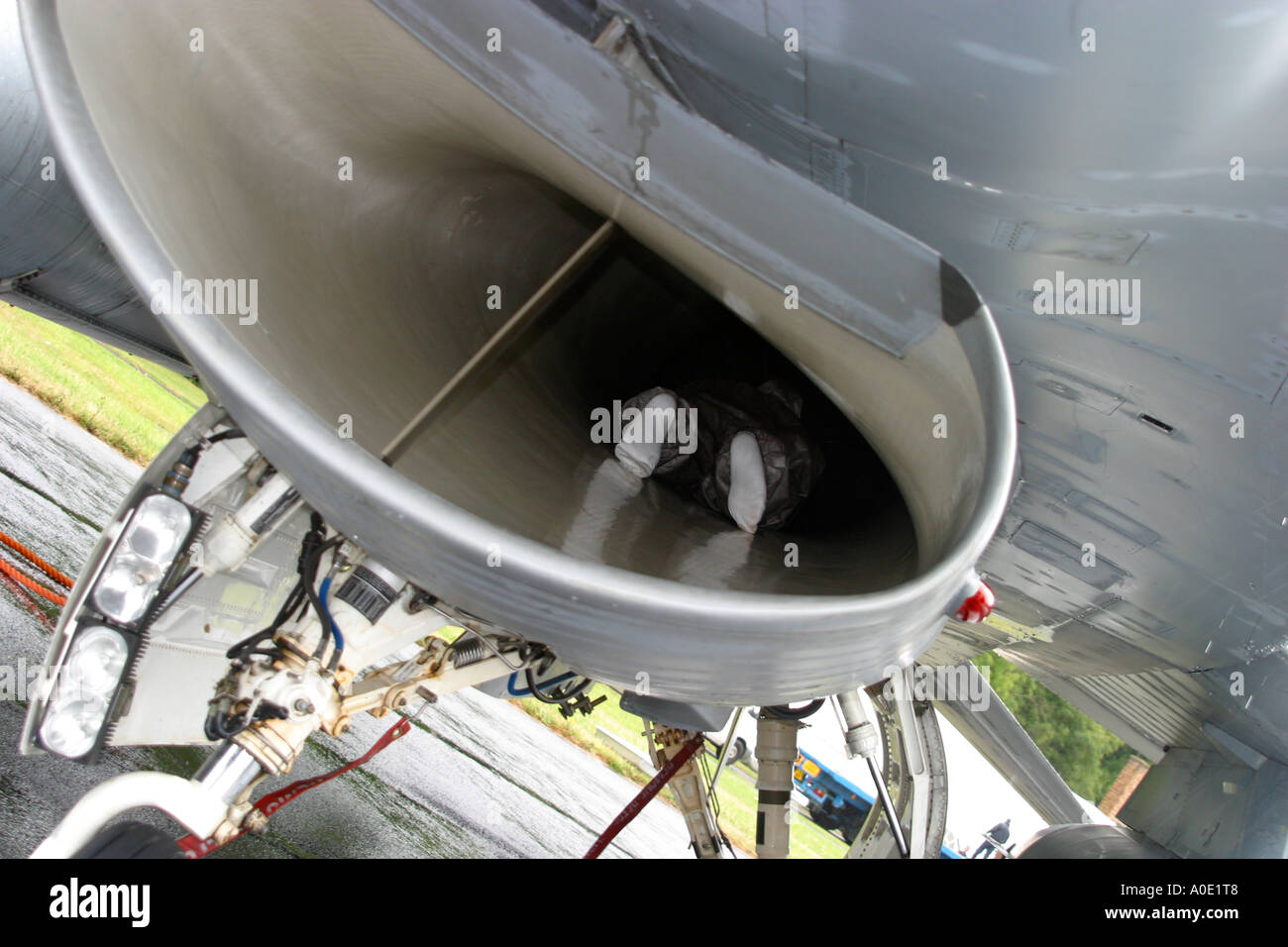 Pilot inspecting jet air intake on F16 fighter plane Stock Photo