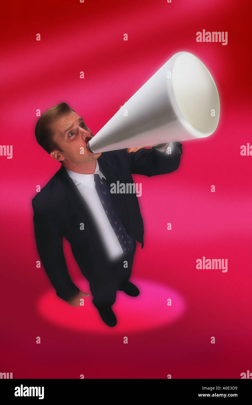 Businessman shouting through megaphone Stock Photo