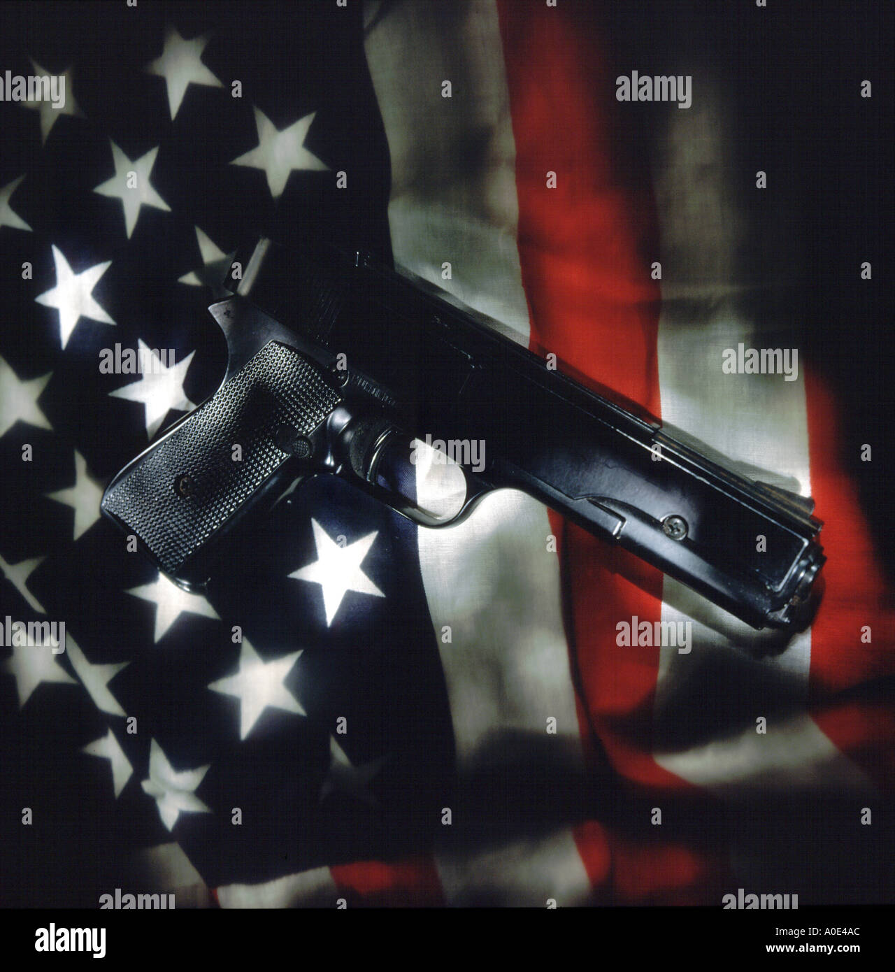 Hand gun with American flag Stock Photo