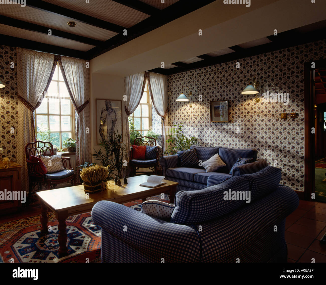 Wallpaper and blue sofa in sitting room Stock Photo - Alamy
