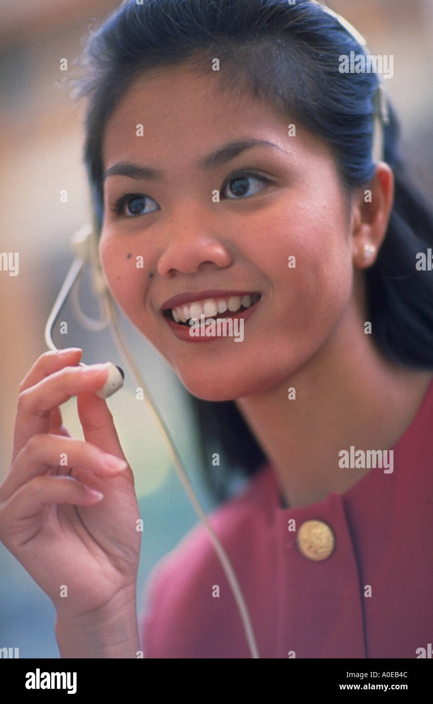 Asian woman using telephone heaset Stock Photo