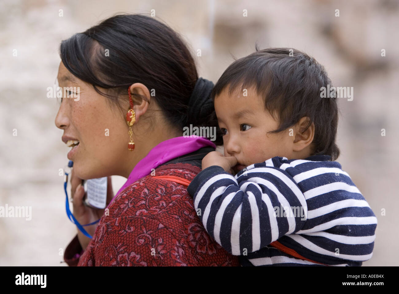 Woman and child with mobile phone- Drepung Monastery Lhasa Stock Photo