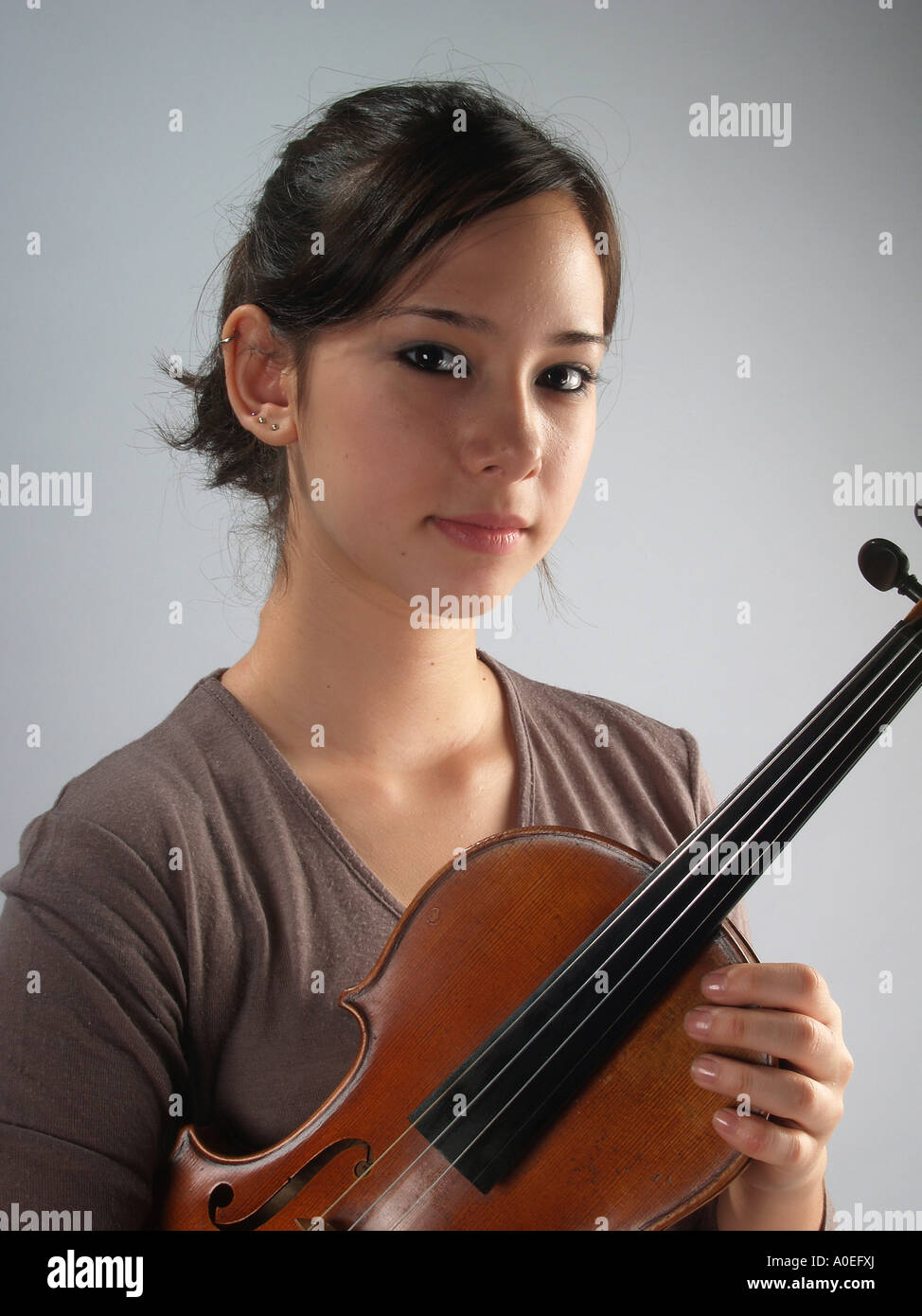 young female violinist holding her violin studio shot Model released ...