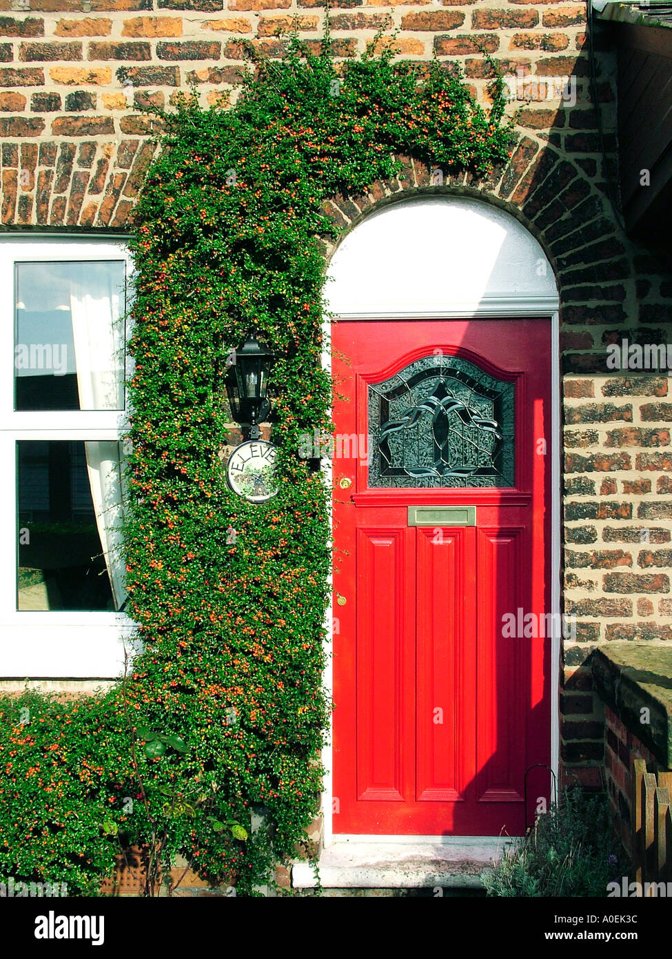 Red cottage door Penketh Warrington England Stock Photo