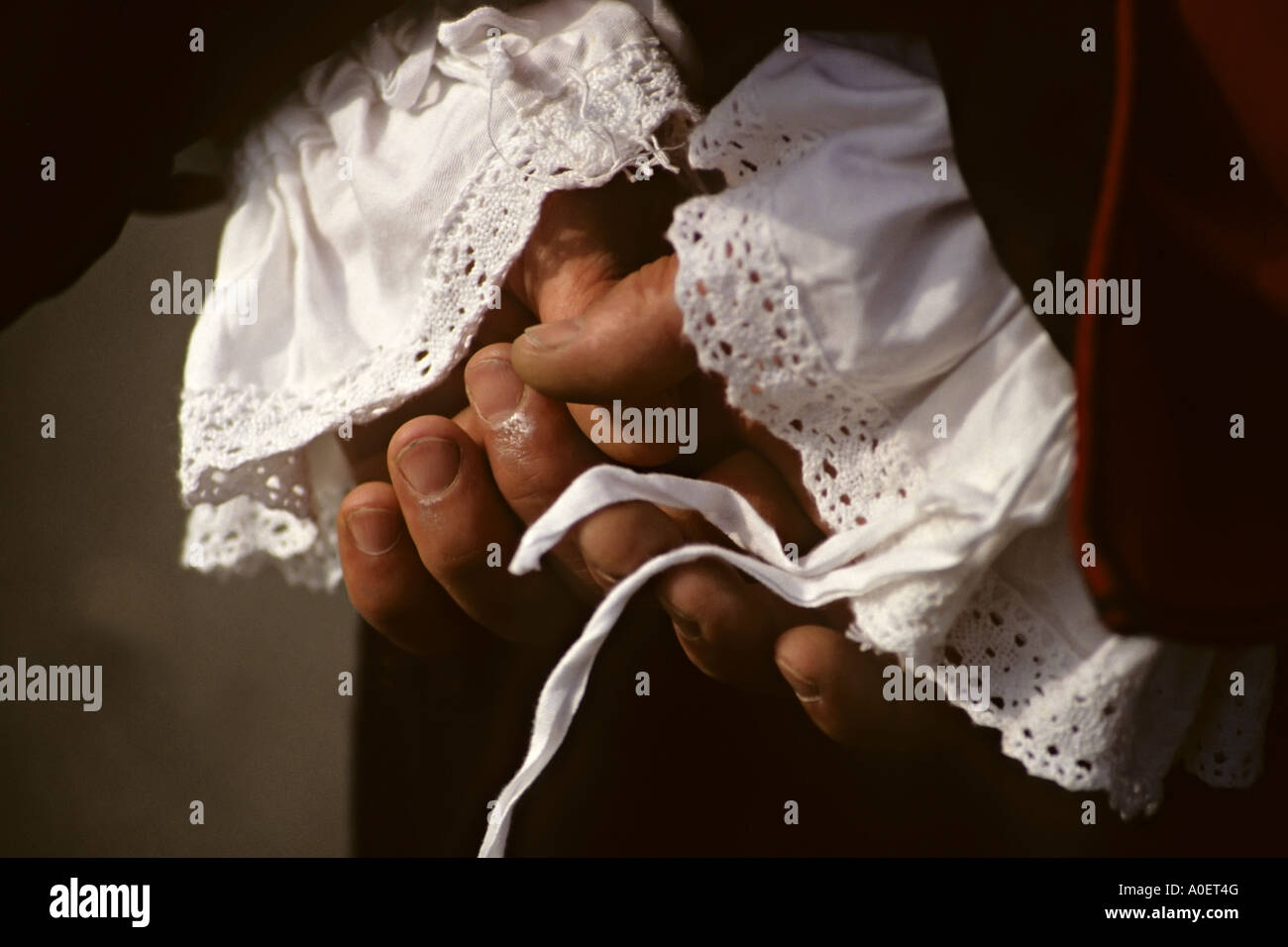 Male hands held behind back of person in period costume from English Civil War Wales UK Stock Photo