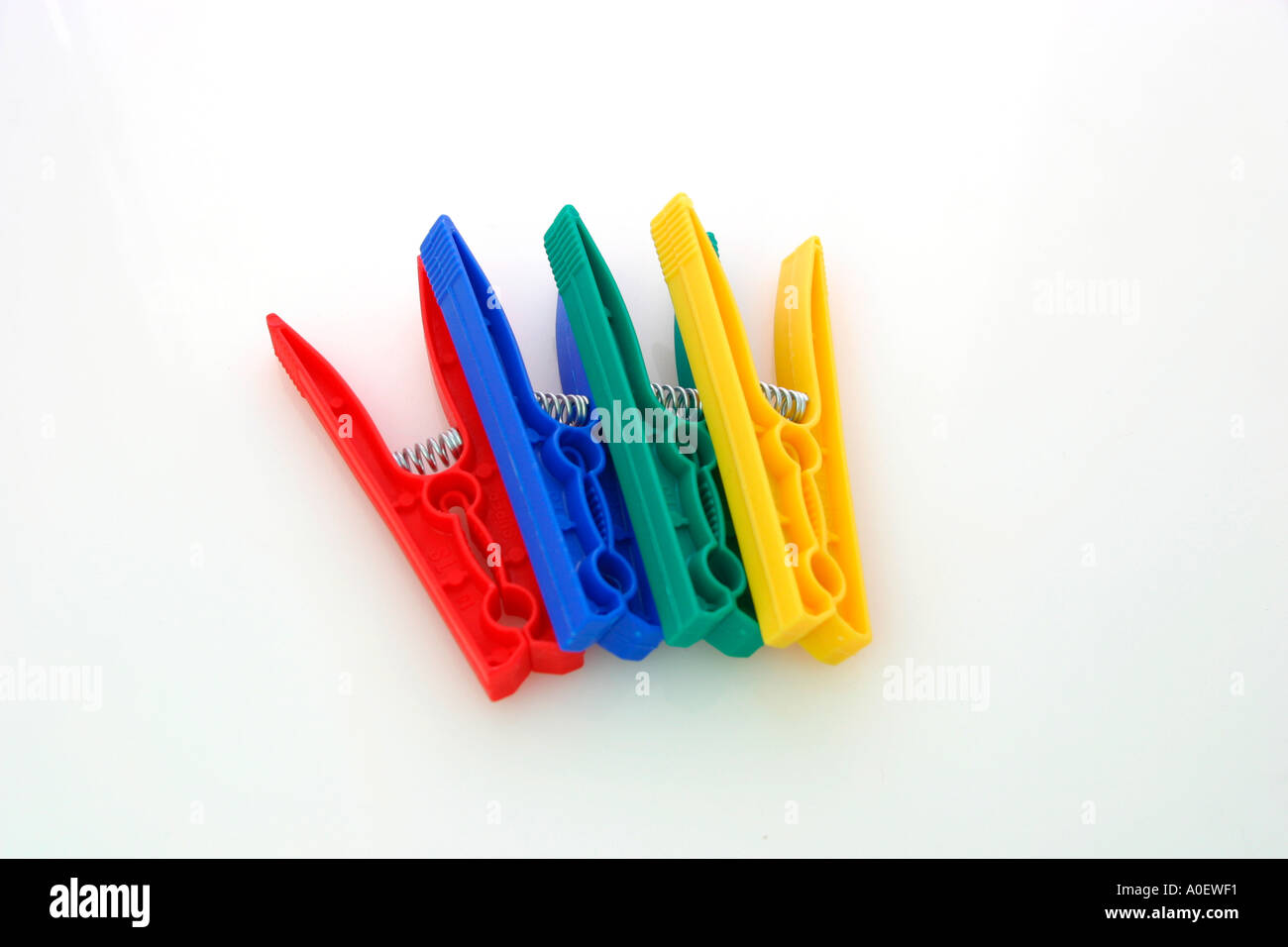 Blue green yellow and red plastic clothes pegs Stock Photo Alamy