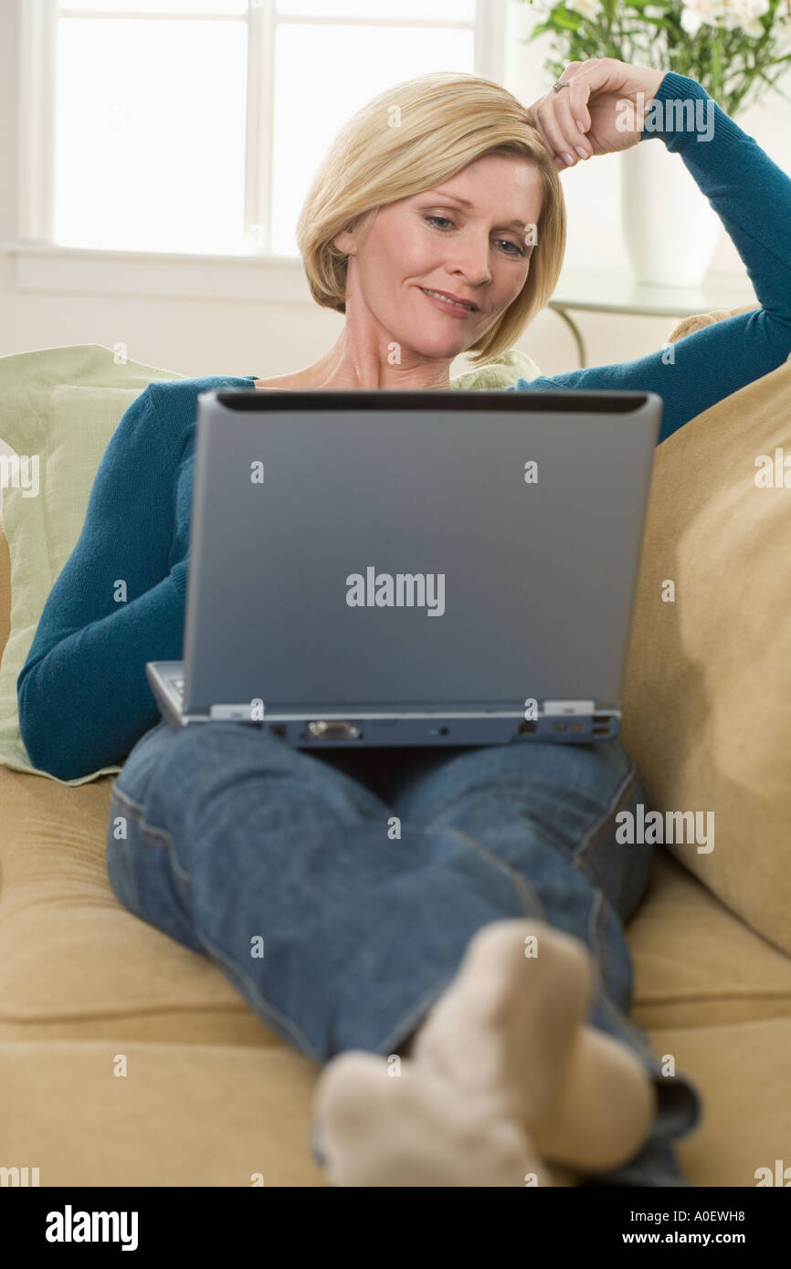 Woman using laptop computer at home Stock Photo