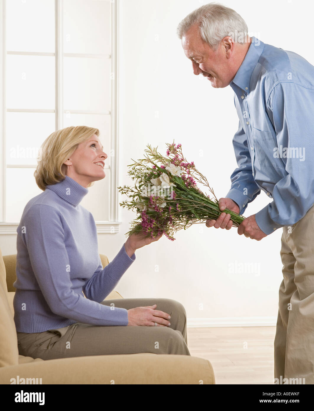Man giving flowers to his wife Stock Photo