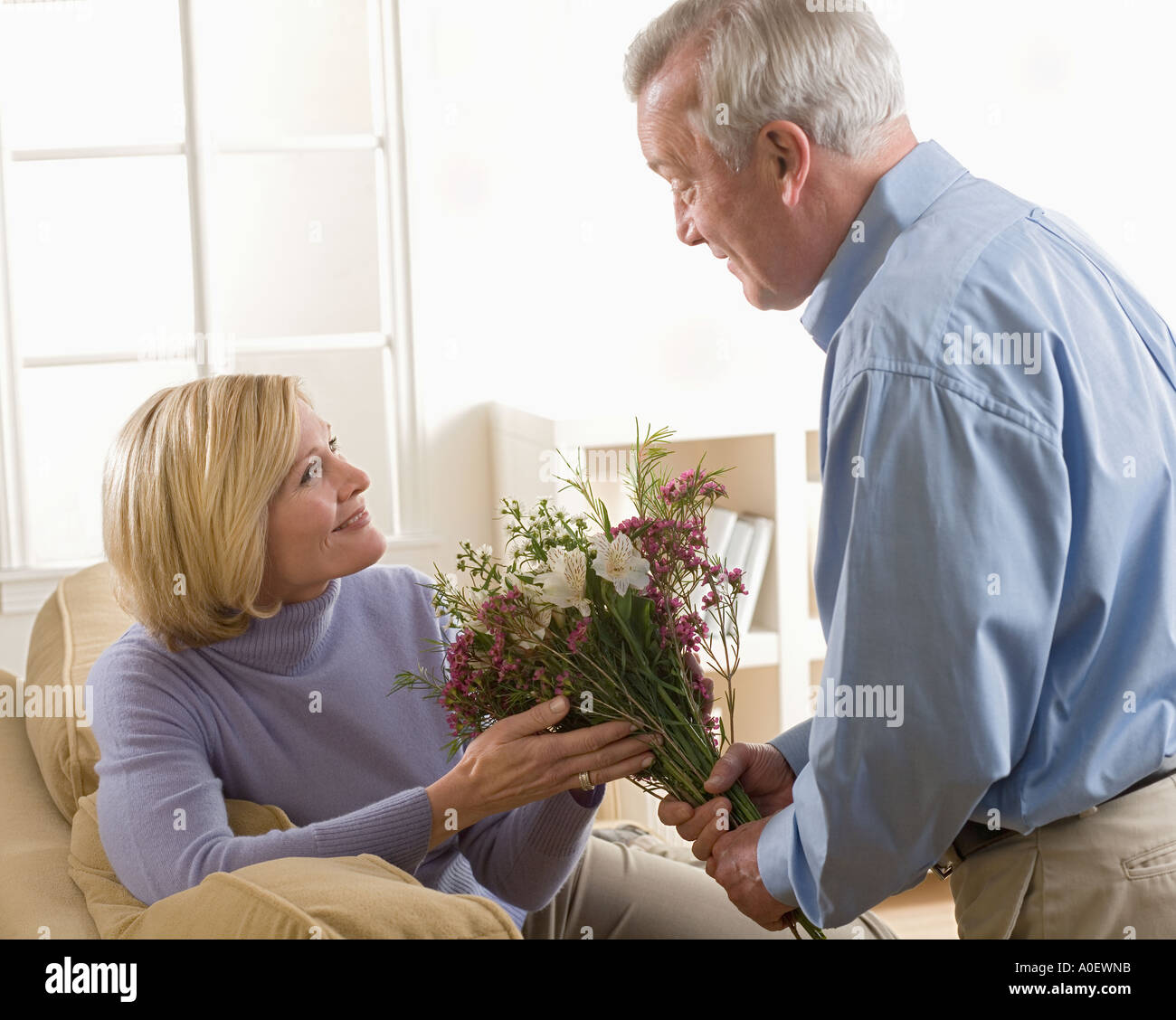 Man giving flowers to his wife Stock Photo Alamy