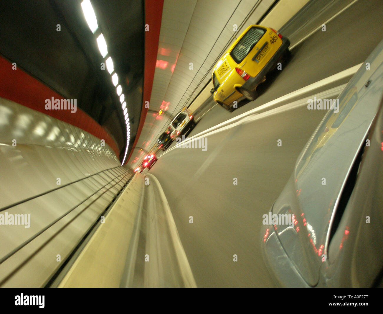 walls blur as car drives through road tunnel Stock Photo