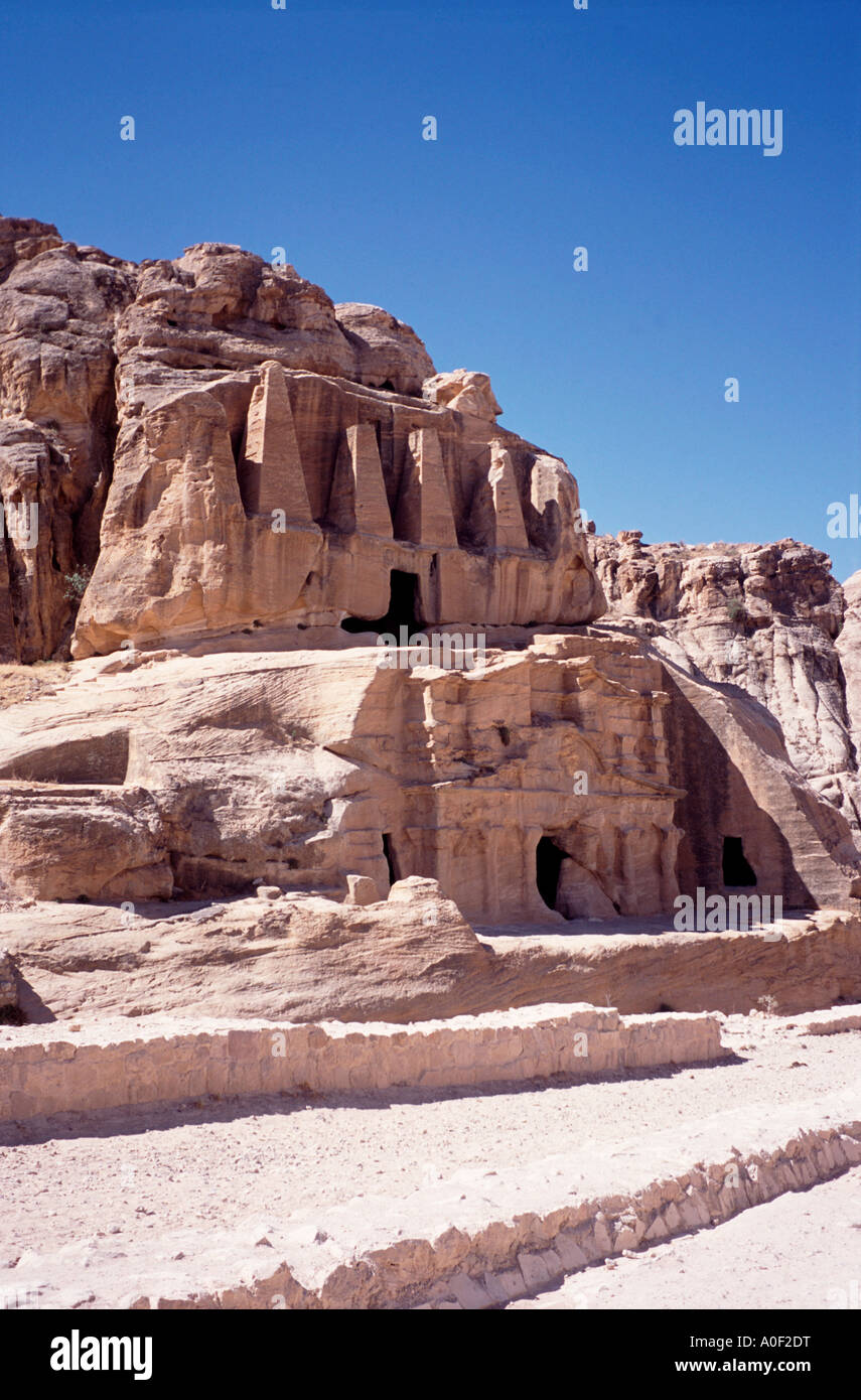 Building carved out of the rock near the entrance to the lost city of Petra Stock Photo