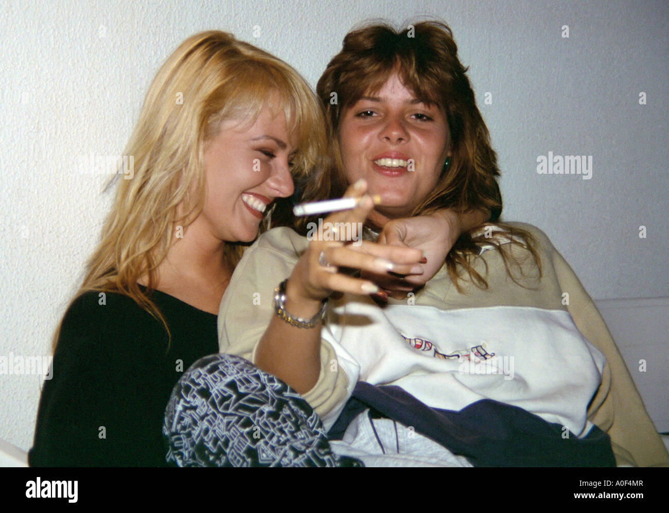 Two Drunk Girls Having a Laugh at a Party Stock Photo