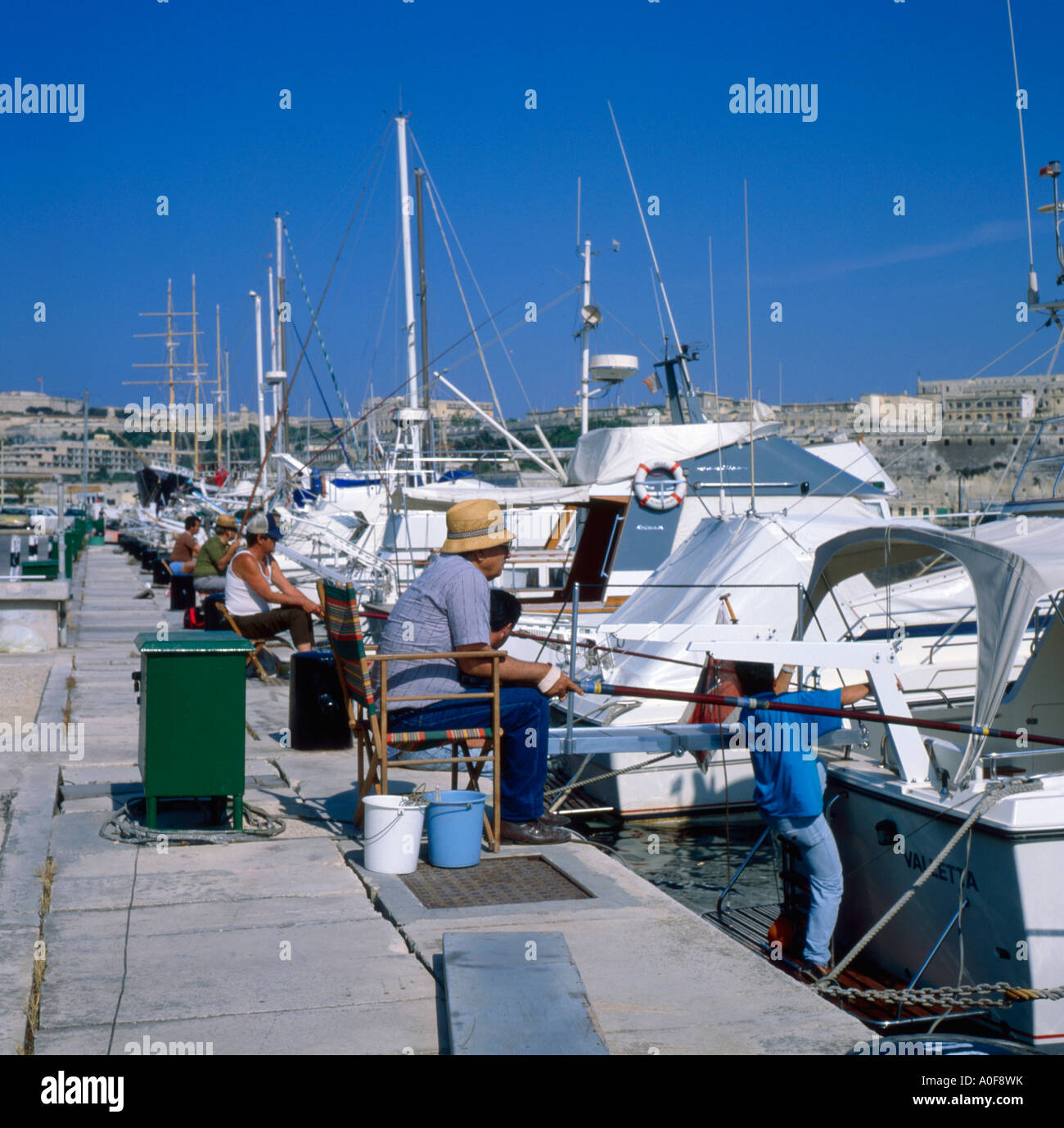 Fishermen at Ta xbiex near Valletta Malta Stock Photo
