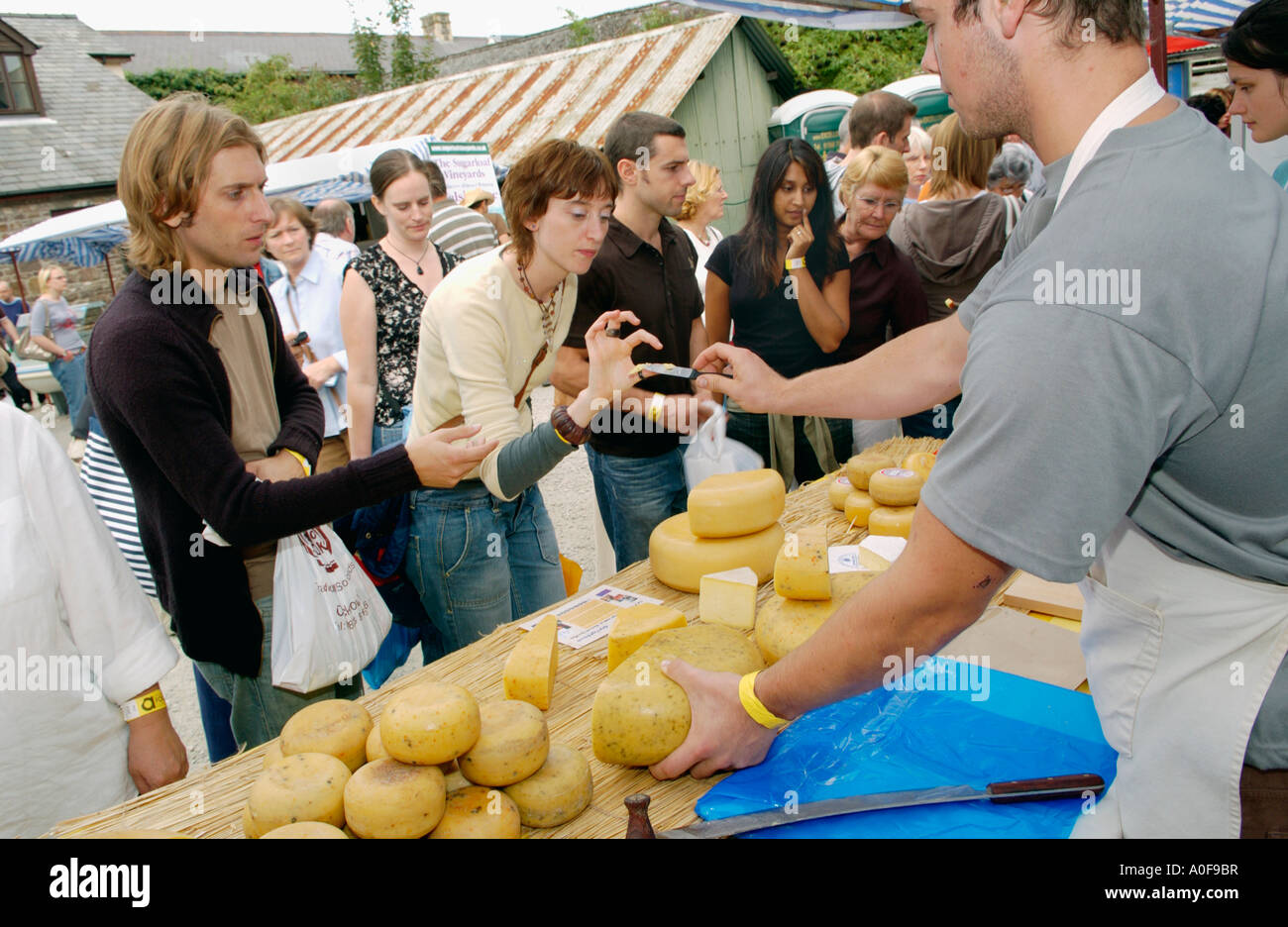 People tasting Teifi Farmhouse Cheese of Llandysul Ceredigion at the annual Abergavenny Food Festival Wales UK GB EU Stock Photo