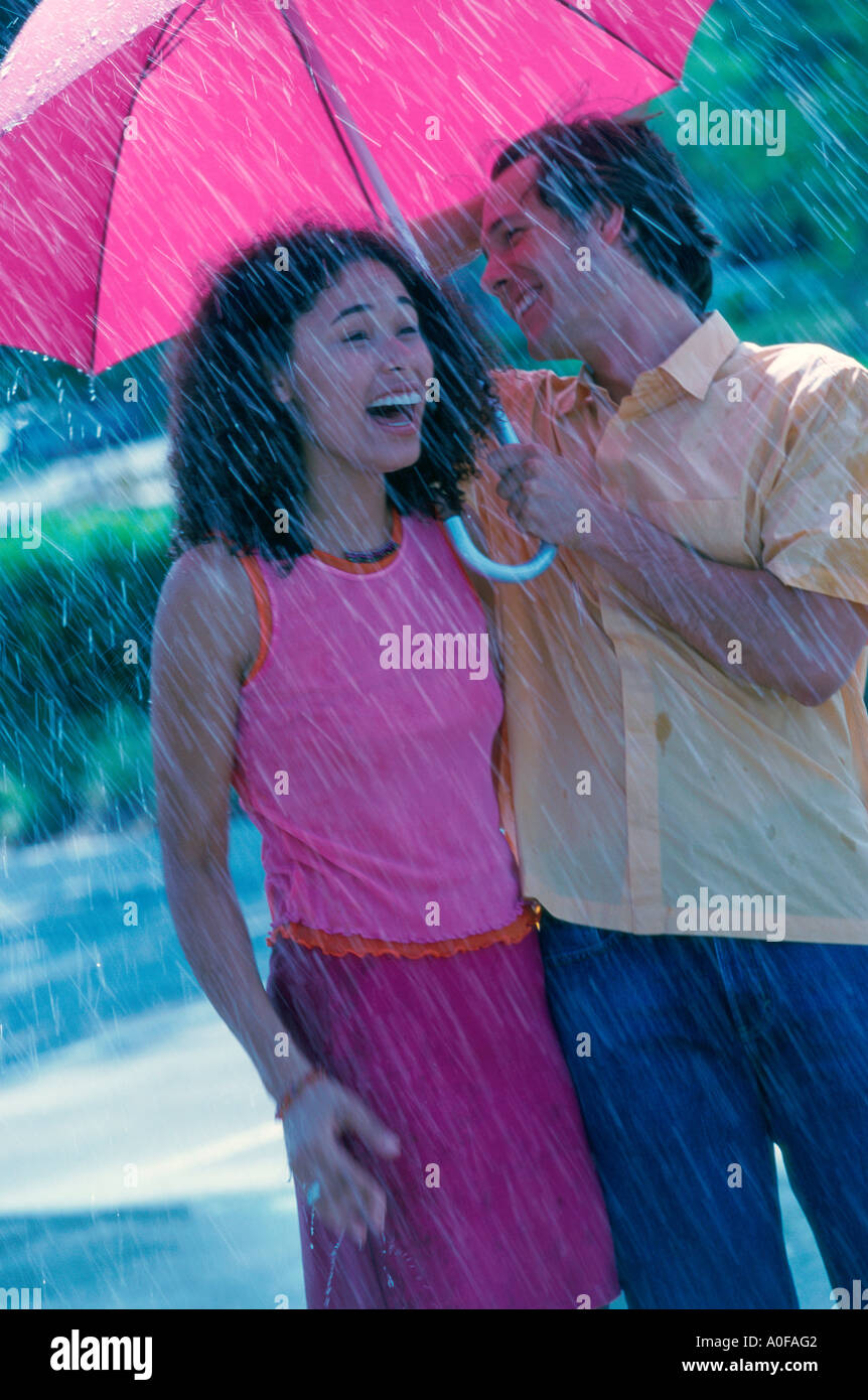 Couple sharing umbrella in rain hi-res stock photography and images - Alamy