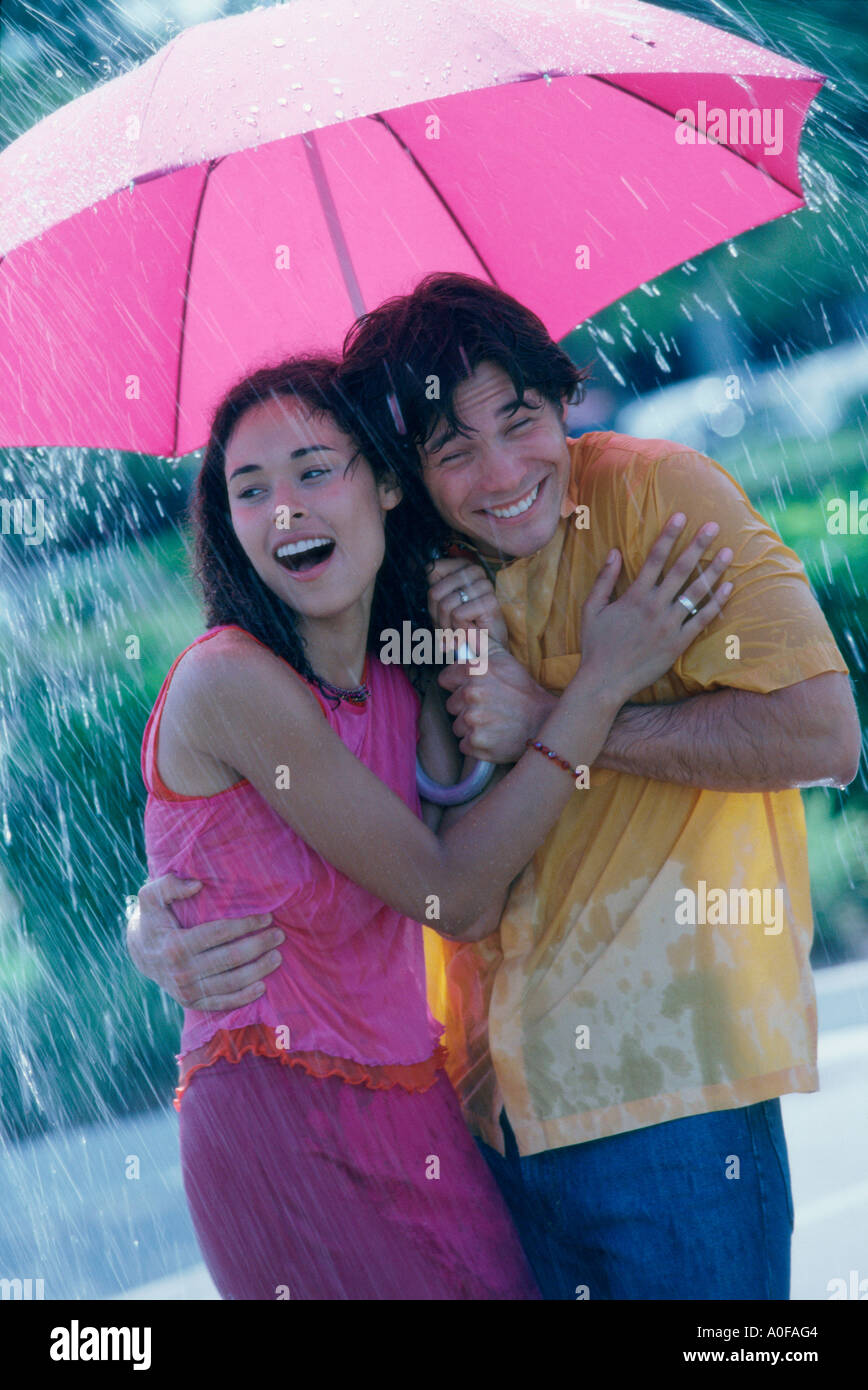 Couple sharing umbrella in rain hi-res stock photography and images - Alamy