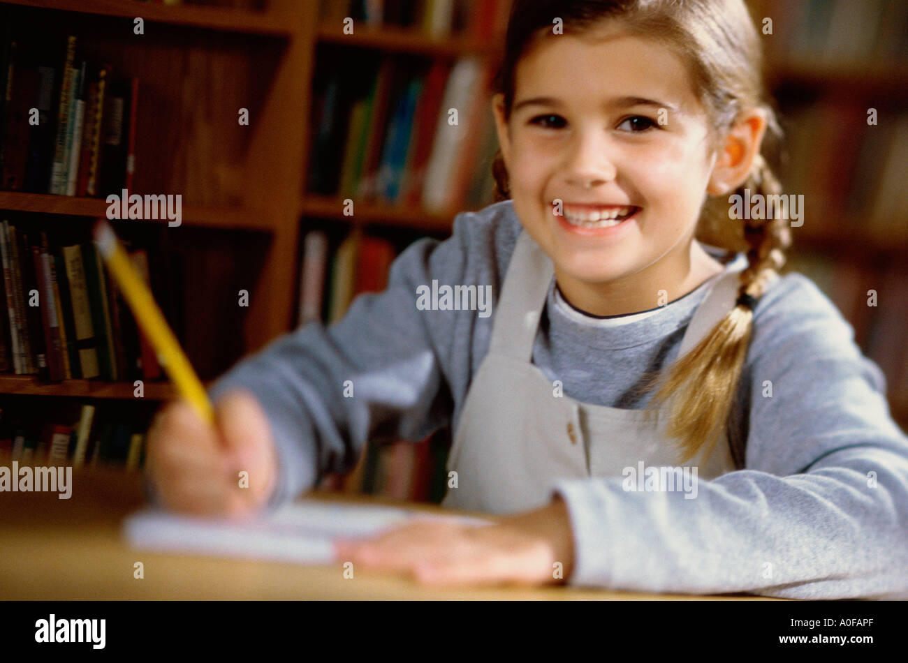 Girl holding book in front hi-res stock photography and images - Alamy
