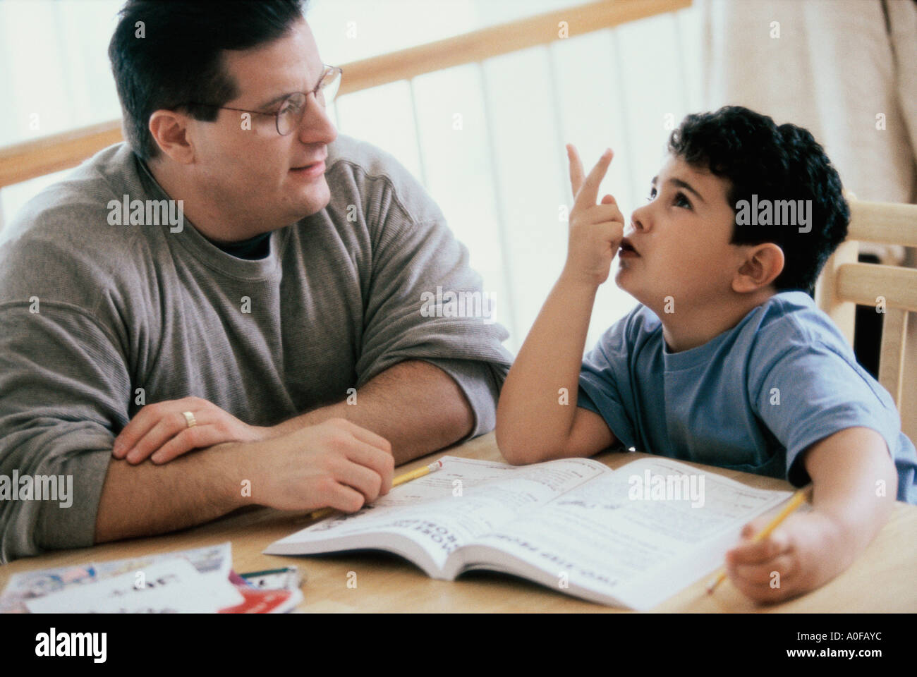 Father helping his son with homework Stock Photo - Alamy