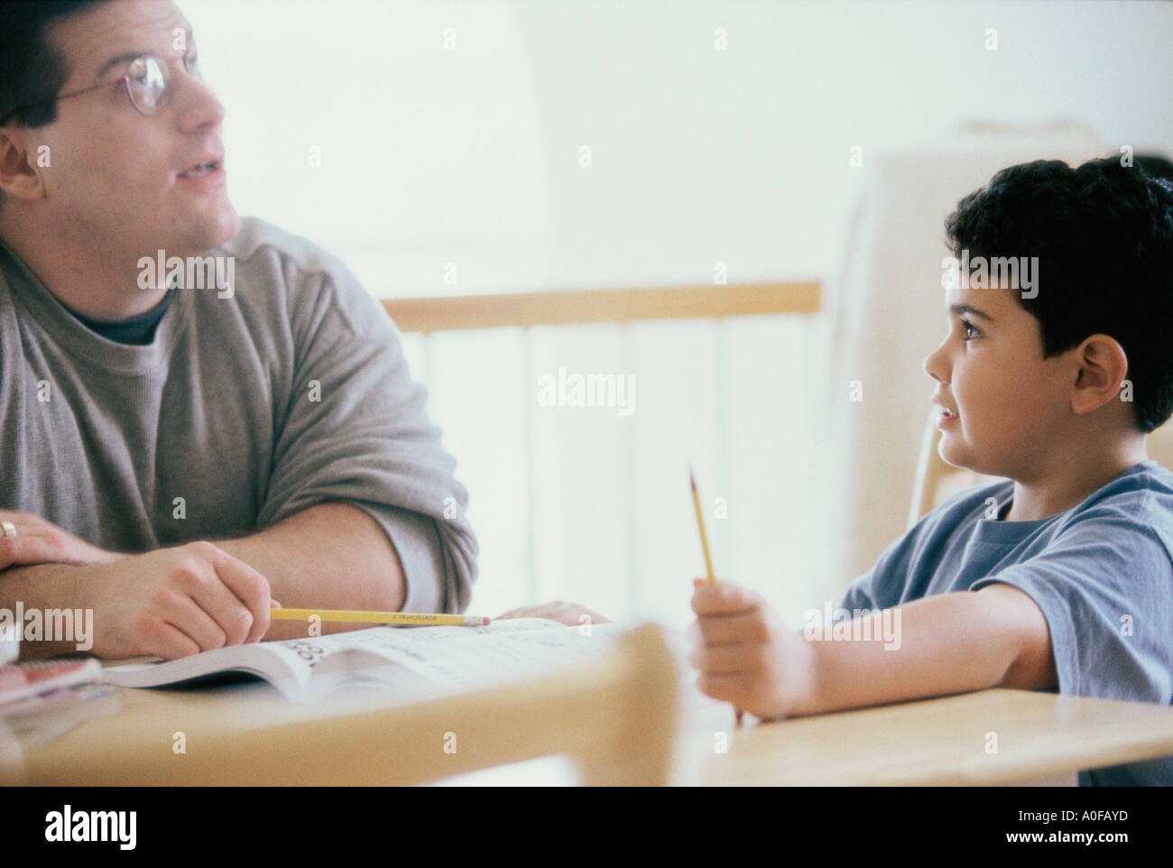 Father helping his son with homework Stock Photo - Alamy