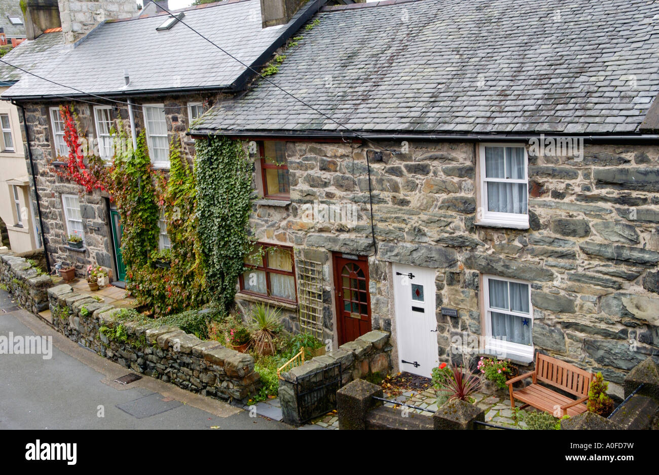 Terrace of traditional stone built terraced cottages typical of the region in Harlech Gwynedd North Wales UK Stock Photo
