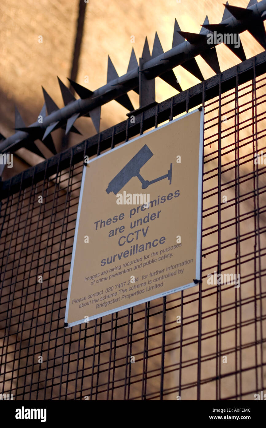 Surveillance camera warning sign on protected gate Stock Photo - Alamy