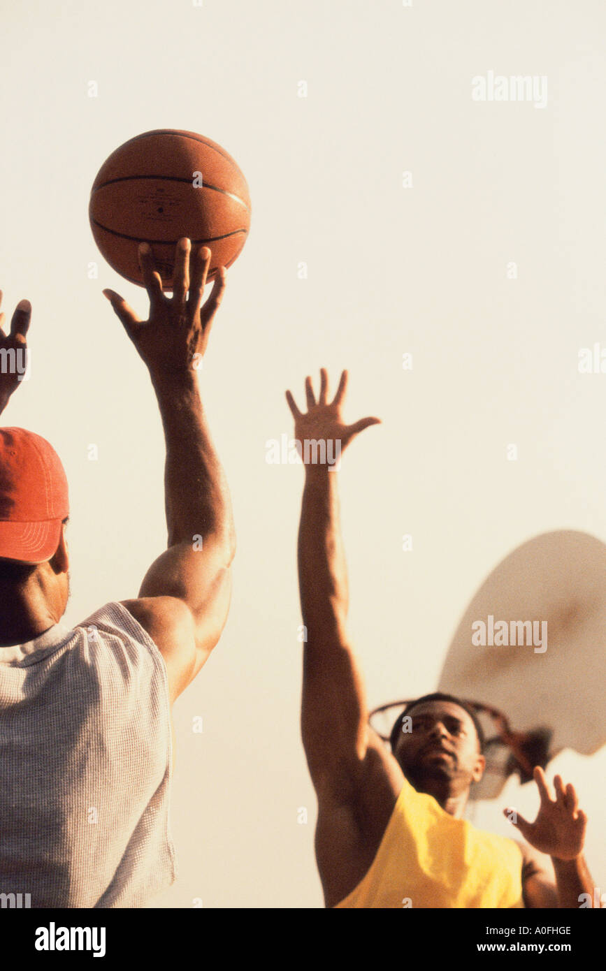 Low angle view of two men playing basketball Stock Photo