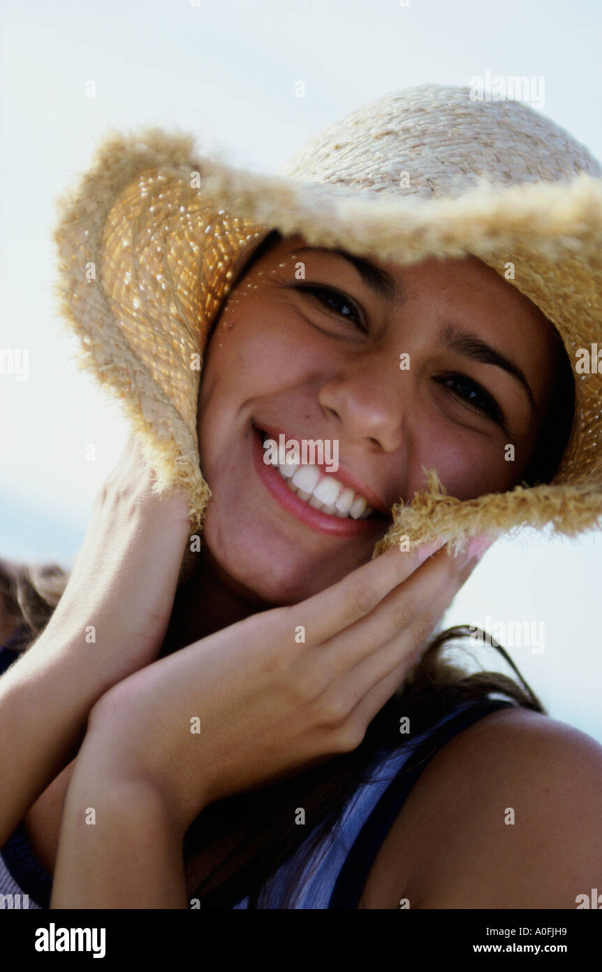 Portrait of a teenage girl wearing a straw hat smiling Stock Photo - Alamy
