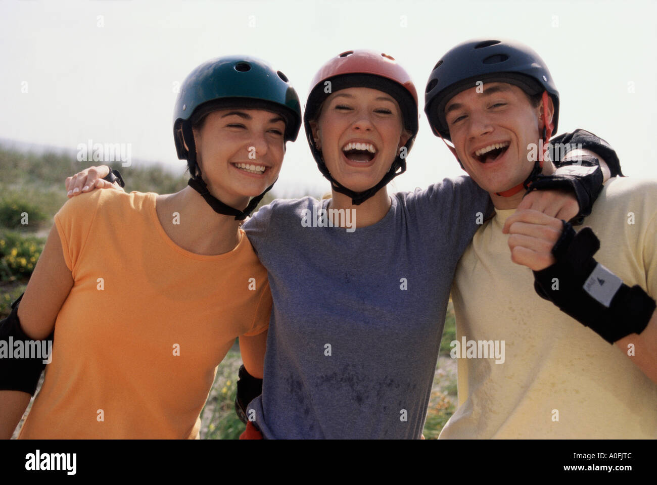 Portrait of two teenage girls and a teenage boy smiling Stock Photo - Alamy