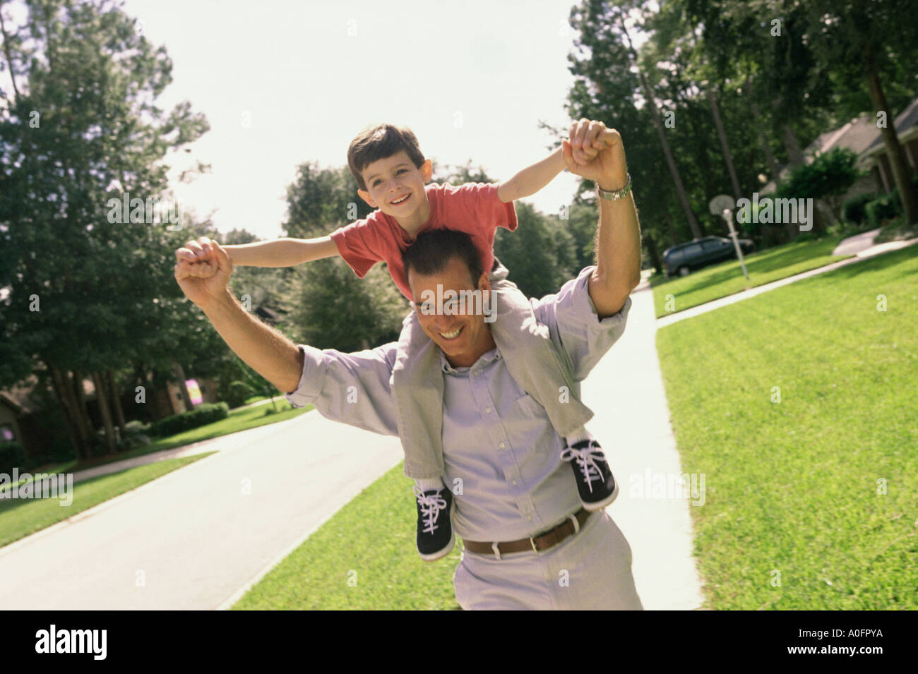 Father carrying his son on his shoulders Stock Photo - Alamy