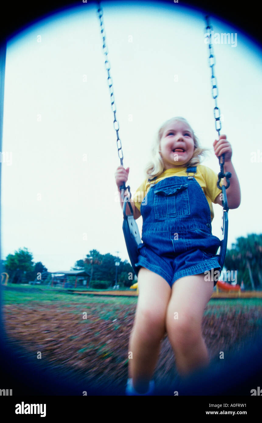 Girl sitting on a swing Stock Photo - Alamy