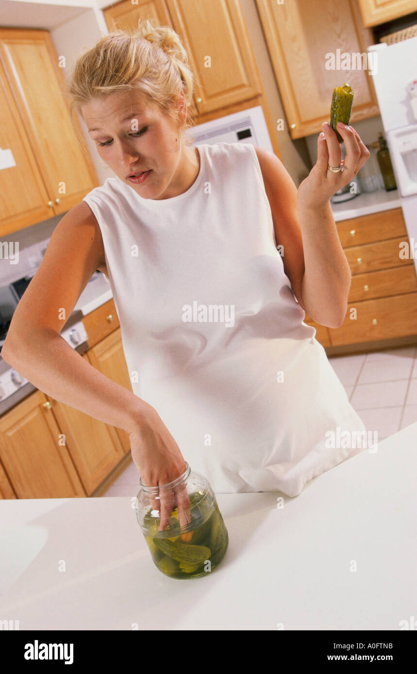 Pregnant woman taking pickles from a jar Stock Photo Alamy