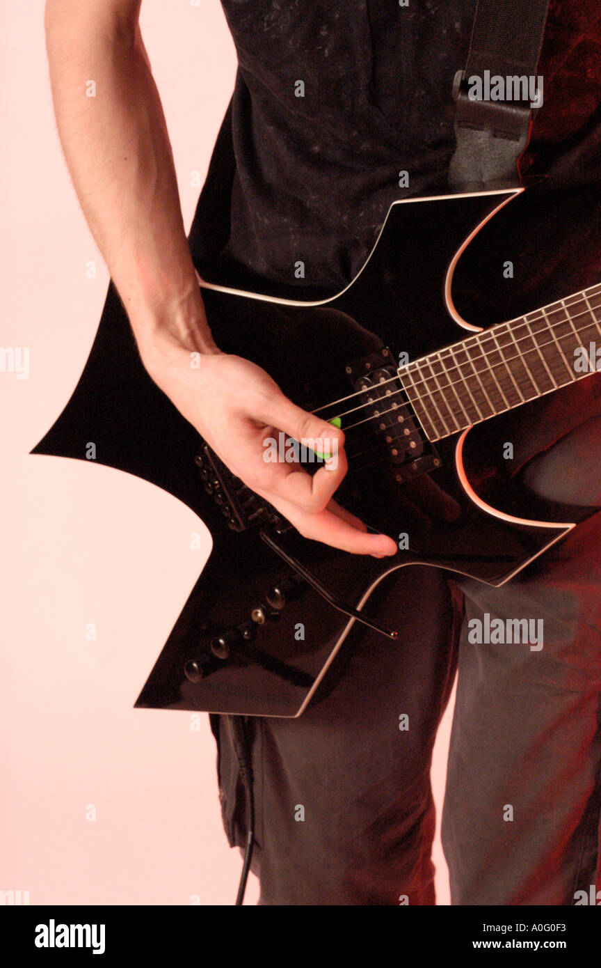 Study of a young male playing an electric guitar Stock Photo