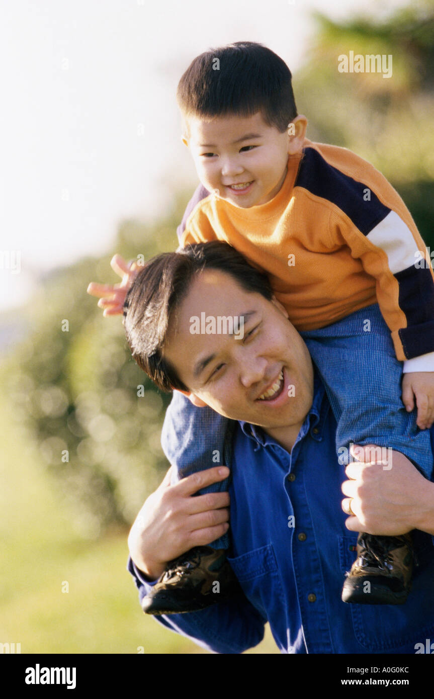 Father carrying his son on his shoulders Stock Photo - Alamy