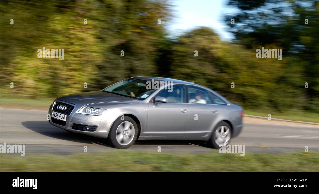 silver audi car speeding through the british countryside Stock Photo